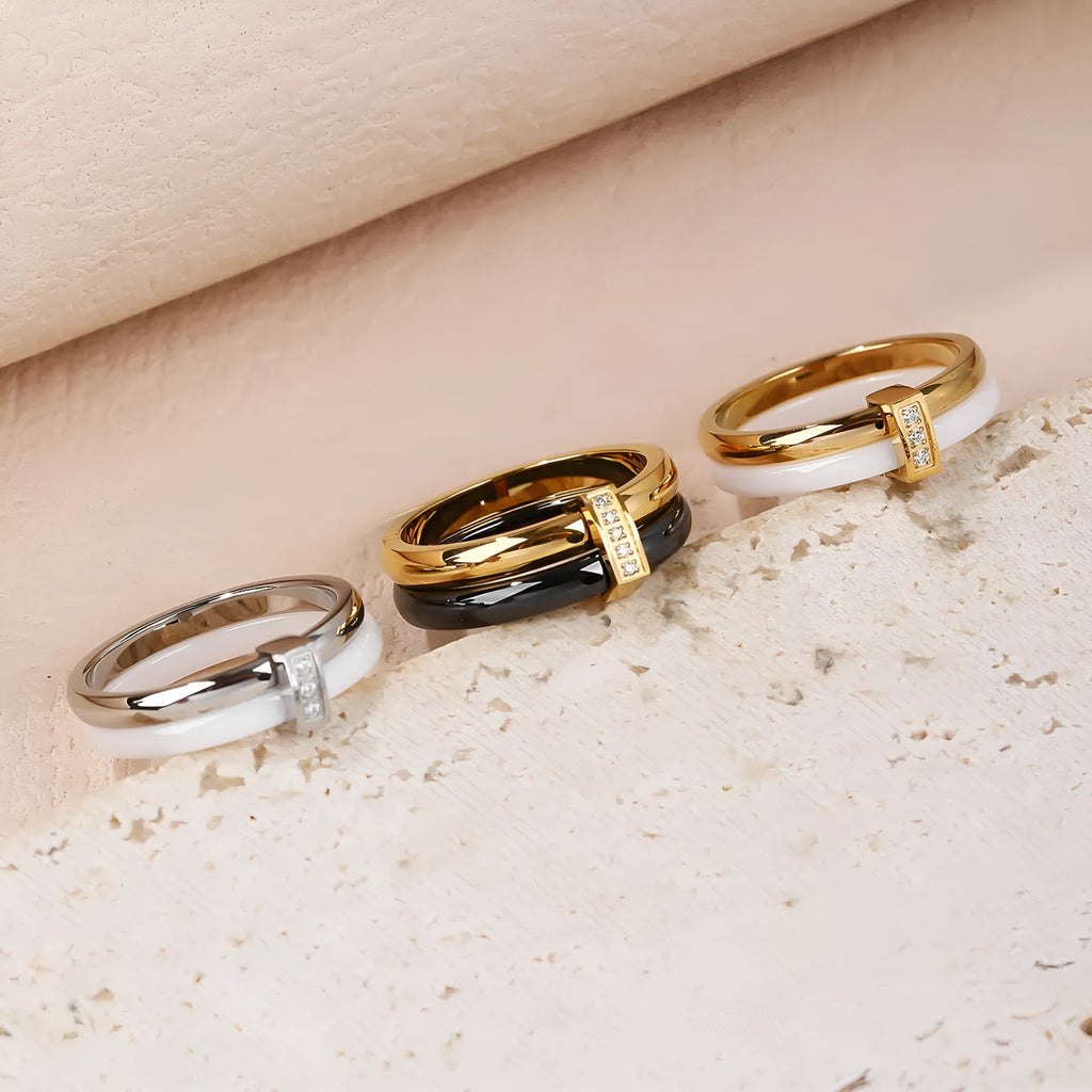 A glossy titanium steel women's double ring with a heart-shaped zirconium inlay, shown in steel white colour.