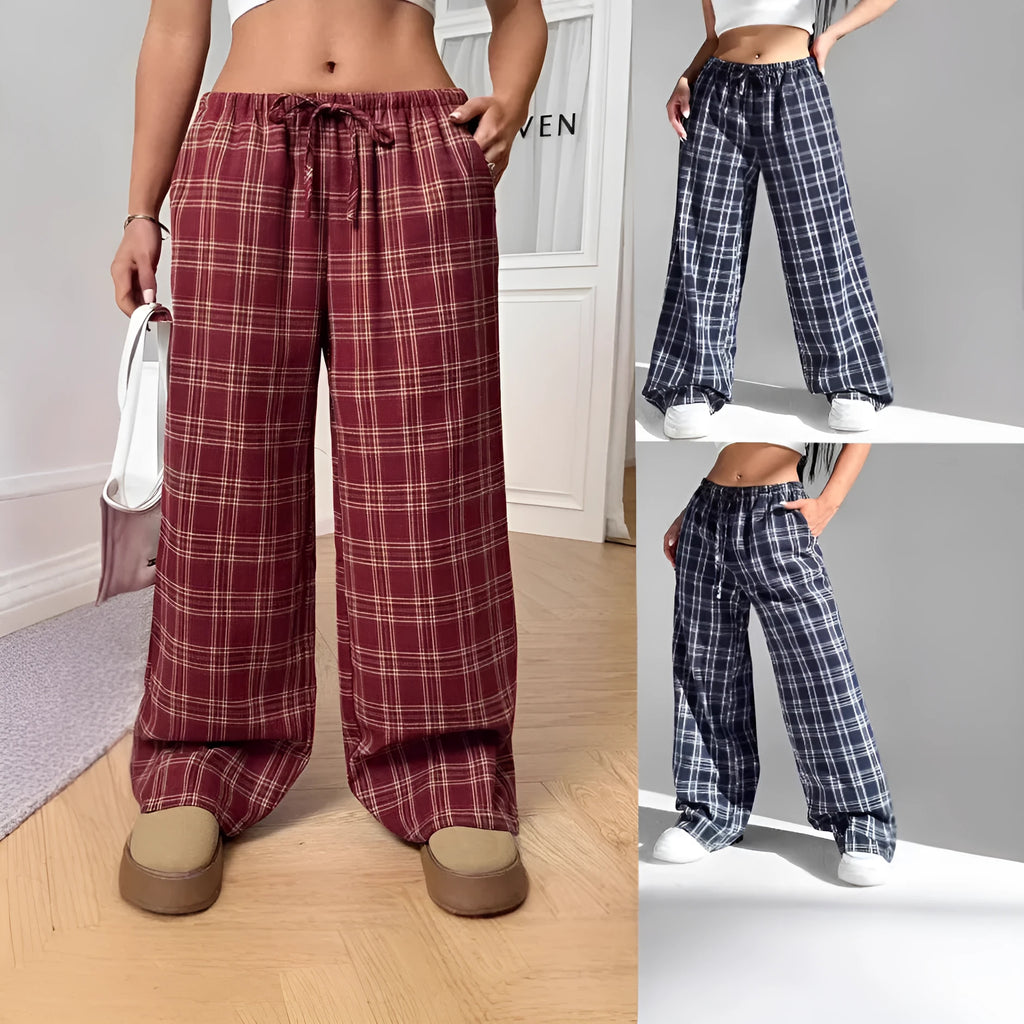 Blue women's loose fit casual trousers with a drawstring waist and front pockets on a hanger.