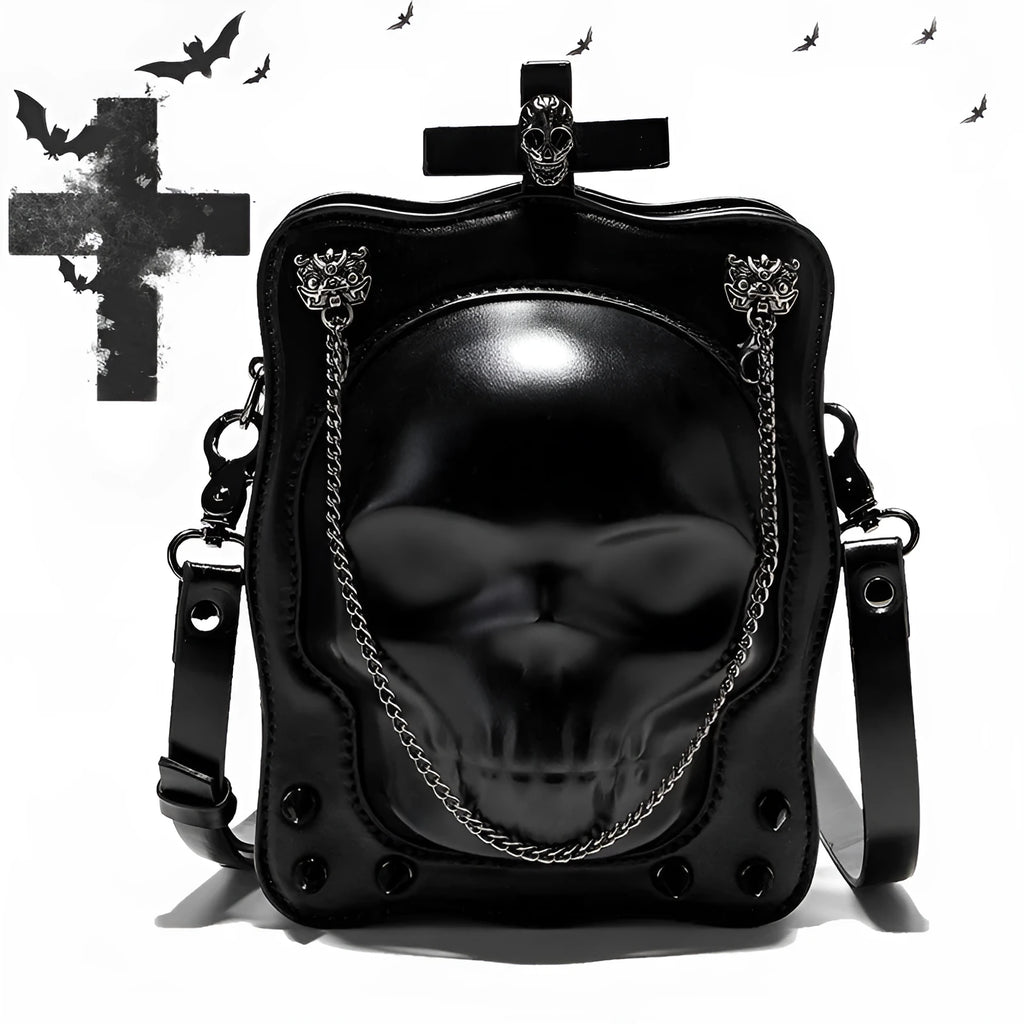 Black mini square crossbody bag with embossed skull design, metal chain strap, and zip closure.