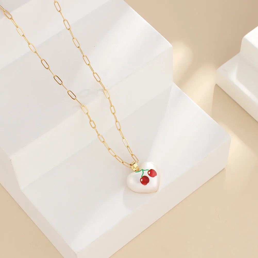 Geometric fruit pendant necklace with adjustable chain showing strawberry pineapple apple pear cherry designs