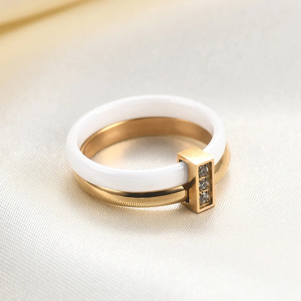 Glossy black ceramic women's ring with round inlaid detail on a 6mm wide geometric band.