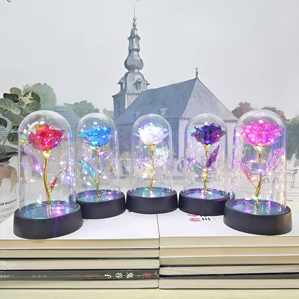 Small decorative night lamp with plastic flowers and a glass-style cover on a black base.