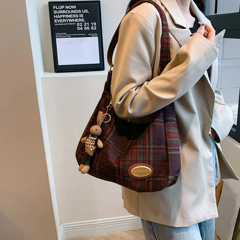 Women's woolen shoulder bag in horizontal square shape with cross-body strap and decorative sewing lines