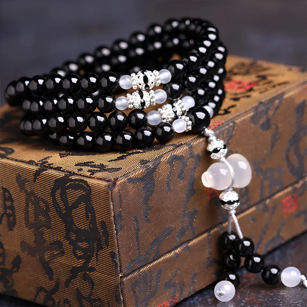 Natural red and black agate 108 bead prayer bracelet with geometric shapes.