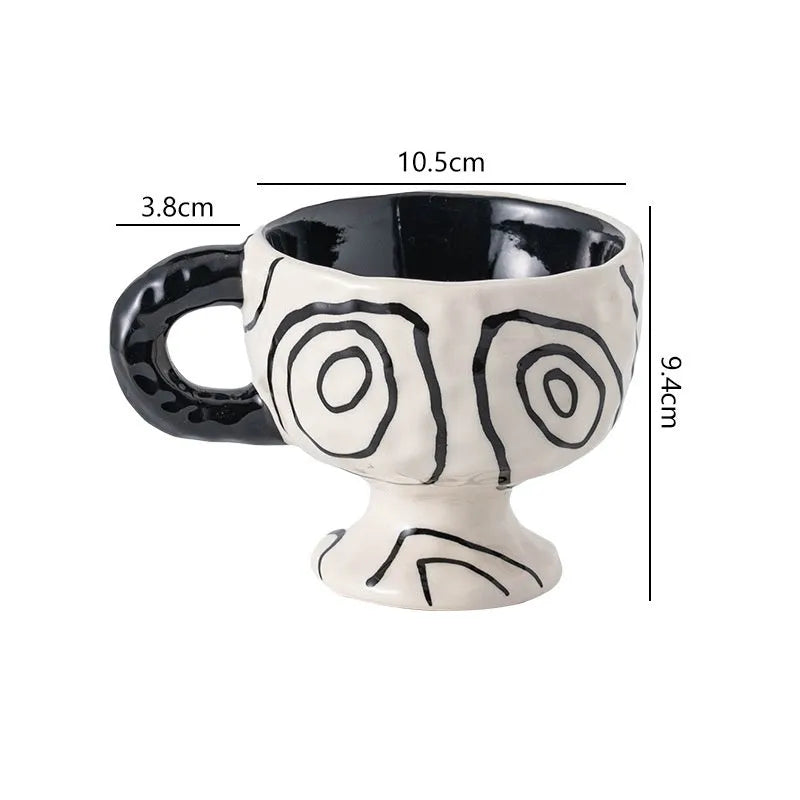 Irregularly shaped hand-pinched ceramic mug in a solid colour, shown on a plain background.
