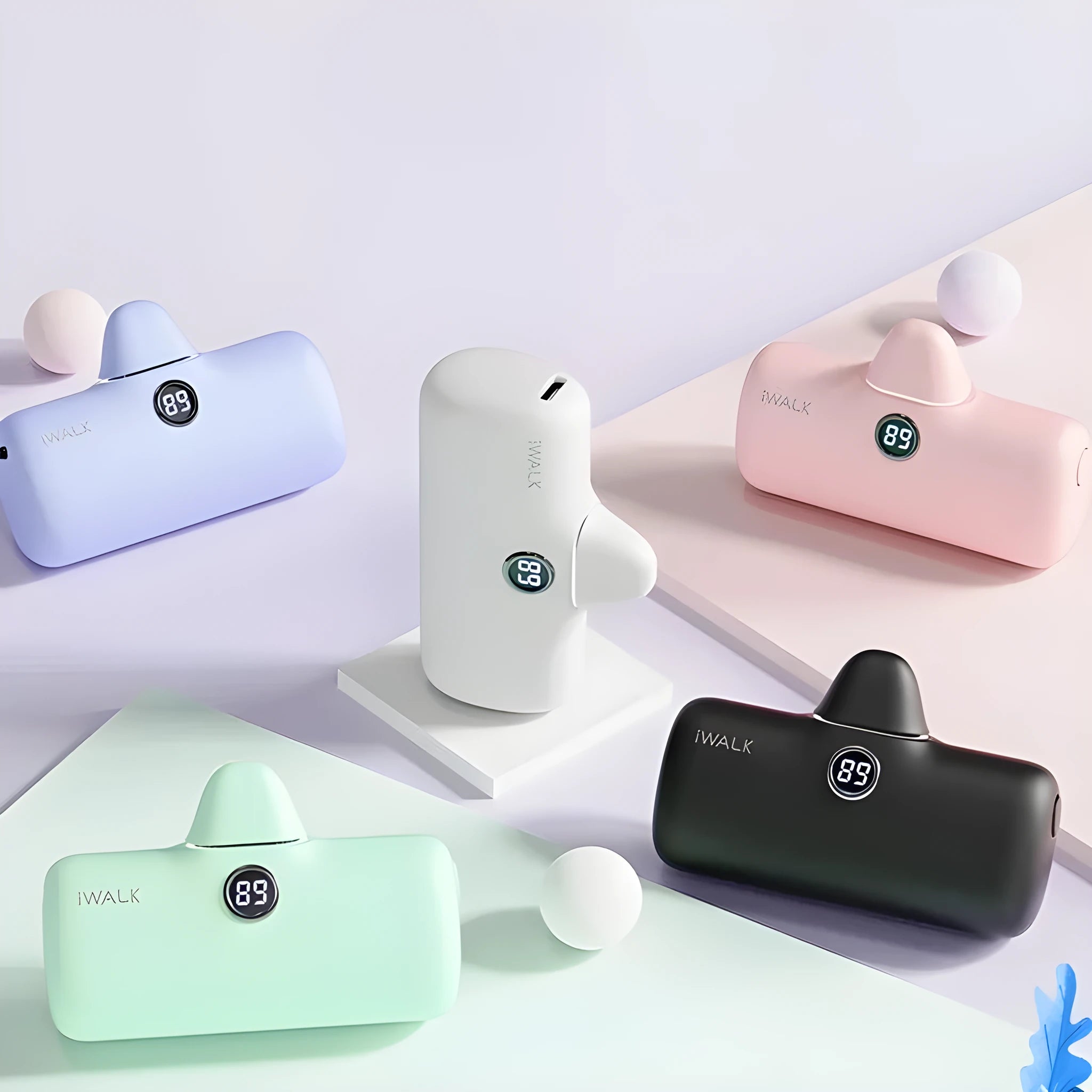 Small cylindrical lipstick tube power bank in purple colour showing digital battery percentage display