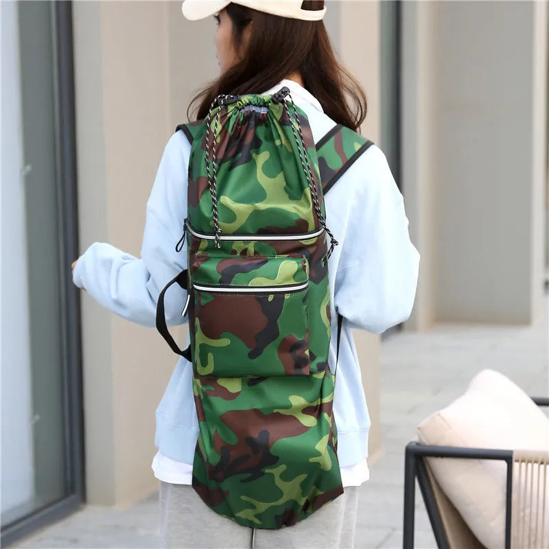 Black waterproof nylon bag for carrying a skateboard and fishing rod, shown with yoga mat.