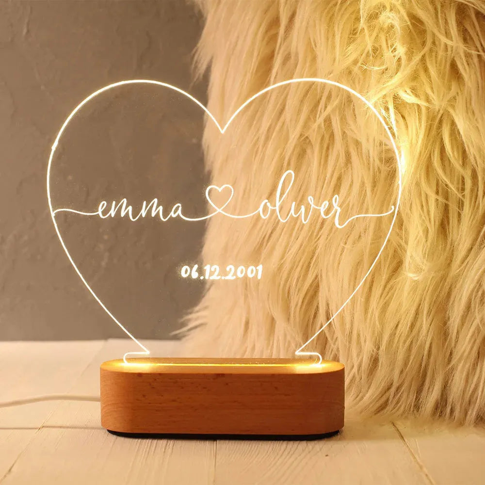 Custom transparent acrylic night light engraved with personal names and a date.