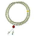 Pale blue Hetian jade bracelet with three circle design and 6mm beads on a wrist.