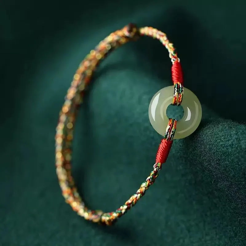 Colourful braided rope bracelet with peace buckle fastening in woven unisex design