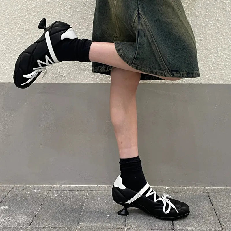 Women's silver low-top sports shoes with lace-up bow and a short stout heel on a viscose sole.