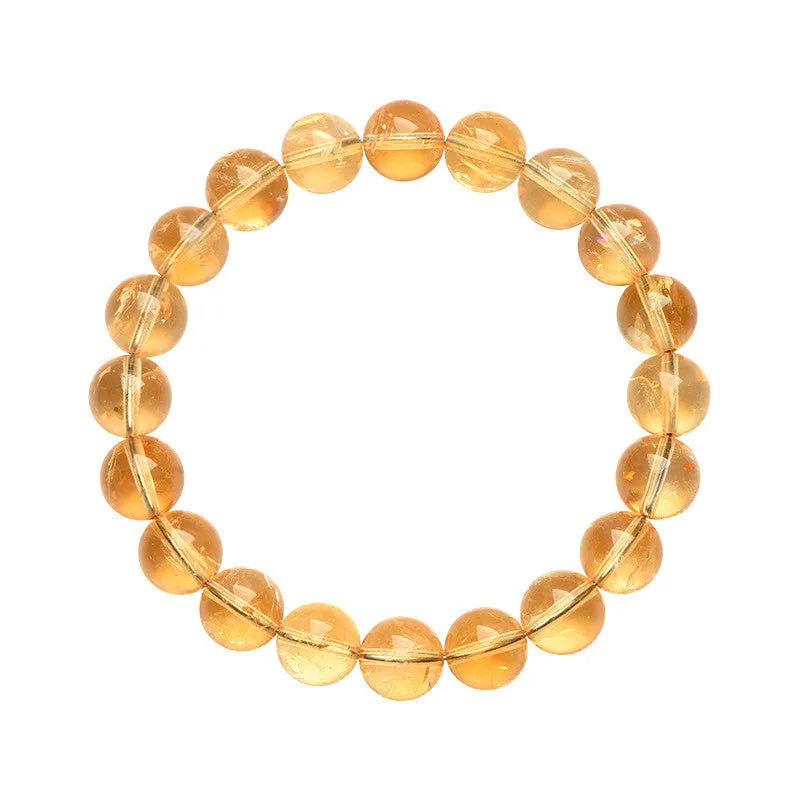 Natural yellow citrine bracelet with geometry-shaped beads in various sizes on a wrist.
