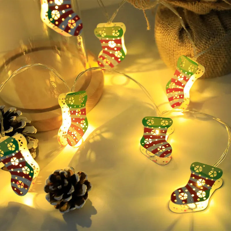 Christmas LED light string with Santa Claus, elk, and snowman ornaments hanging on pine branch