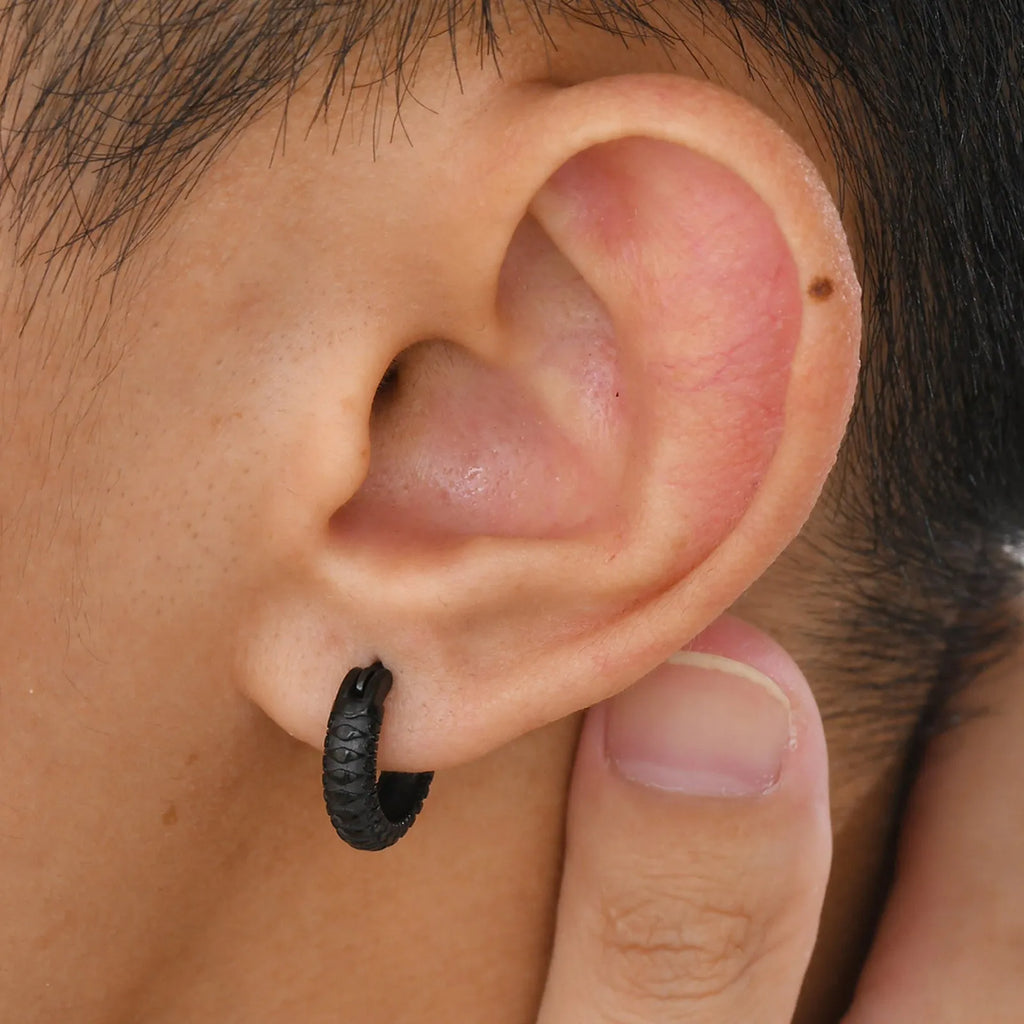 A pair of stainless steel stud earrings for men with a snake pattern, shown in black and gold colour options.