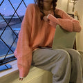 A loose-fit women's pullover sweater in a solid colour, shown in lake blue, purple, and pink options.