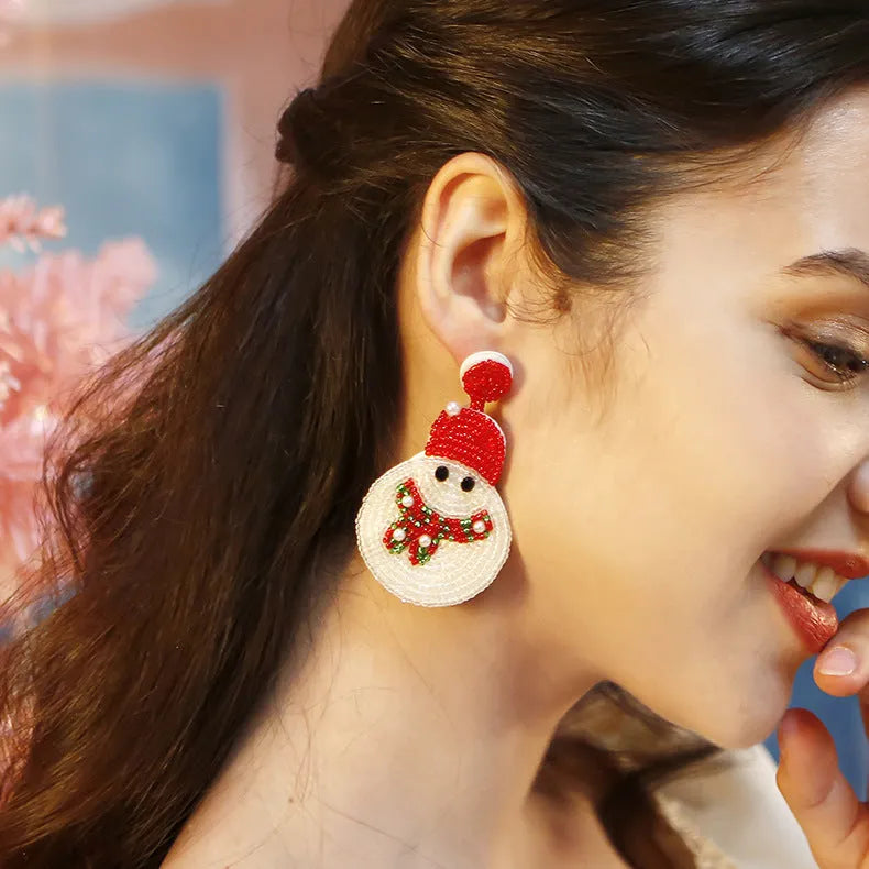 White acrylic snowman bead earrings on a white background, geometric shape, one pair shown