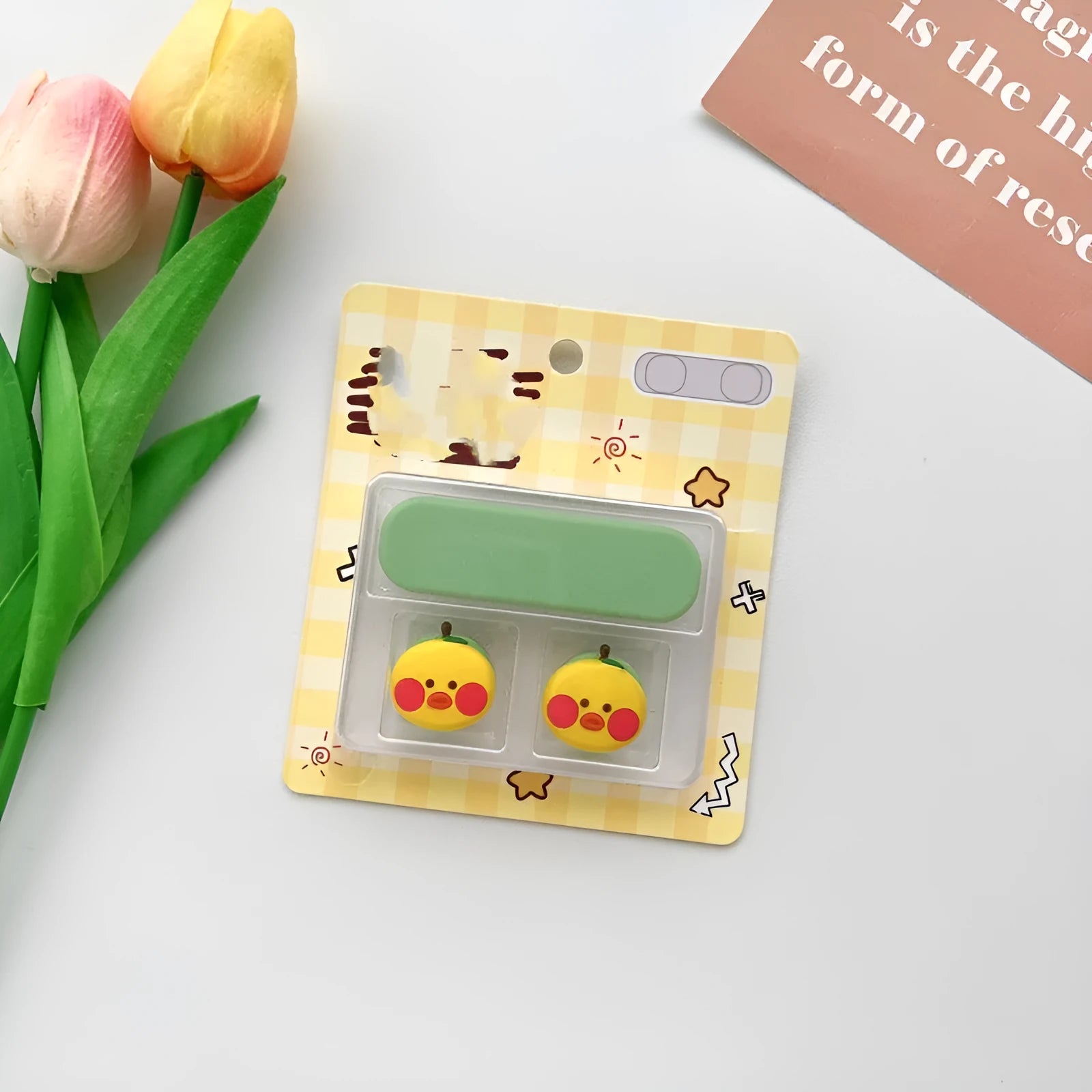 Plastic cartoon-style magnetic data cable fixer clip on a desktop