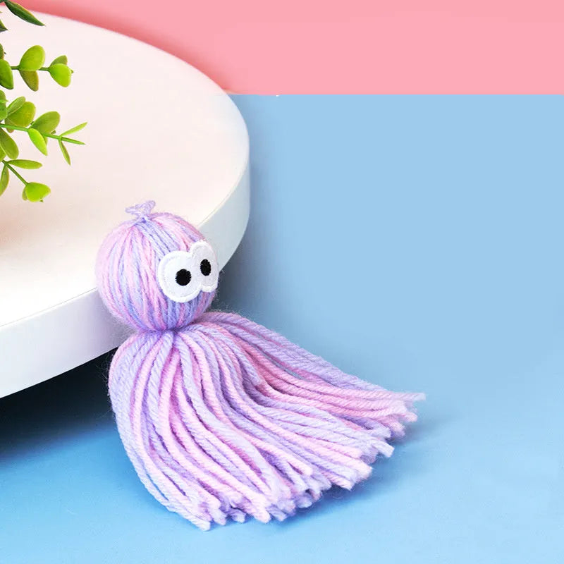 Wool ball cat toy with hanging feature in blue grey colour