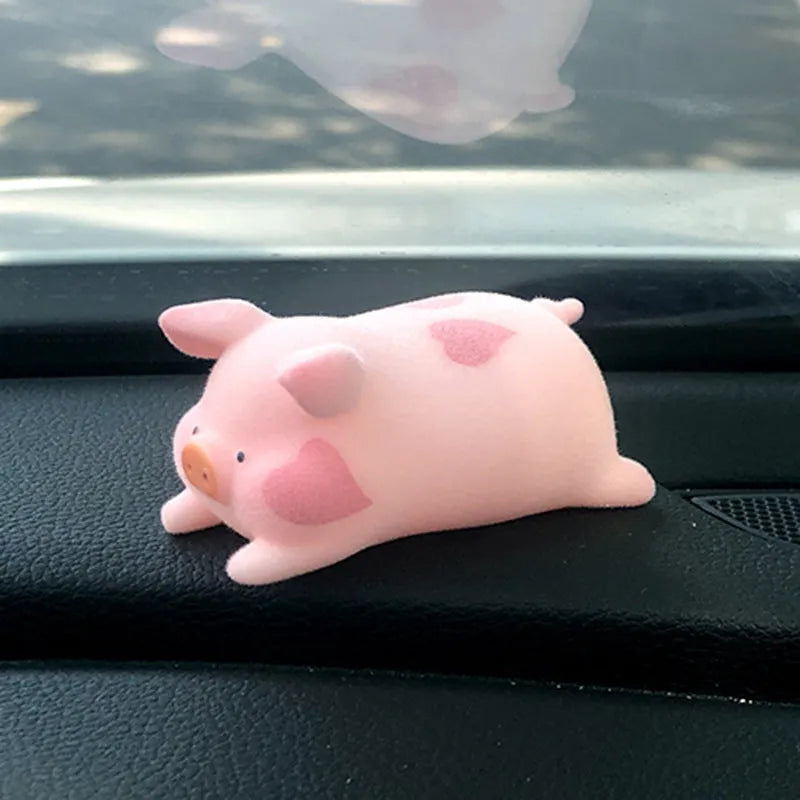 A hard resin cartoon pig car dashboard ornament in one of eight available decorative styles.