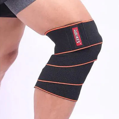 Aolikes orange lifting knee wrap with velcro fastening stretched out for squats