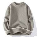 Man wearing a grey loose-fit round neck knitwear pullover sweater for casual autumn wear.
