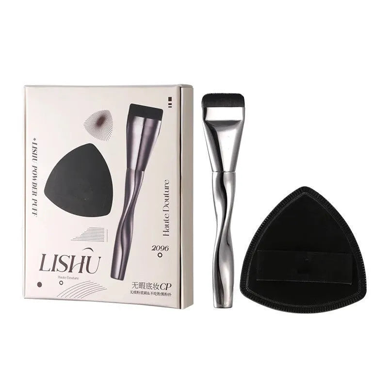 Spiral one-shaped black powder foundation brush with long handle on a white surface next to its storage bag.