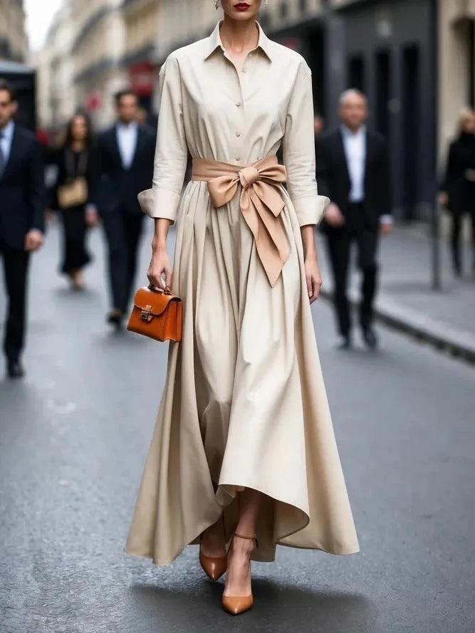 Solid colour lace-up maxi dress in beige with asymmetric hem and pullover neckline on a model.