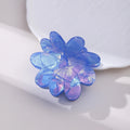 Dazzling blue PVC flower hair clip with glossy finish, 6cm length, on a light background