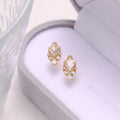 Geometric silver earrings with white crystal studs showing front detail