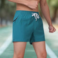 Men's black ice silk high-waisted fitness training shorts on a grey background.