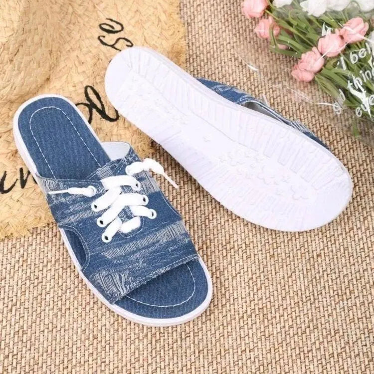 Blue Roman-style canvas slippers with cloth lining and rubber sole showing flat design