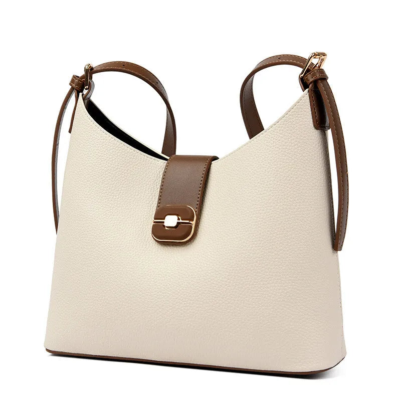 PU bucket bag in beige with contrast stitching, single shoulder strap, and open top showing internal organiser pockets.