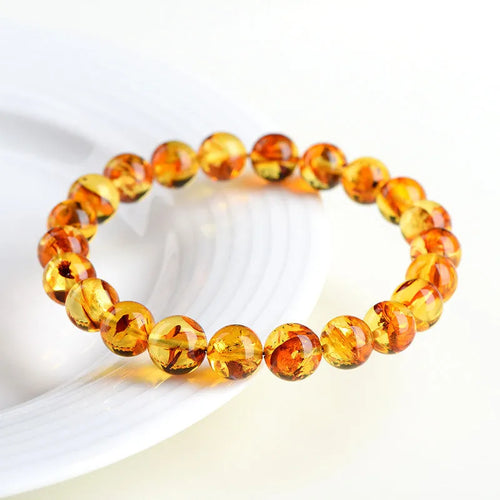 Natural yellow piebald amber bracelet with geometric polished beads.