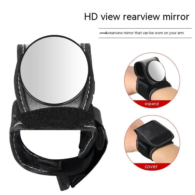 Black nylon bicycle rear-view mirror shown mounted on a cyclist's wrist.