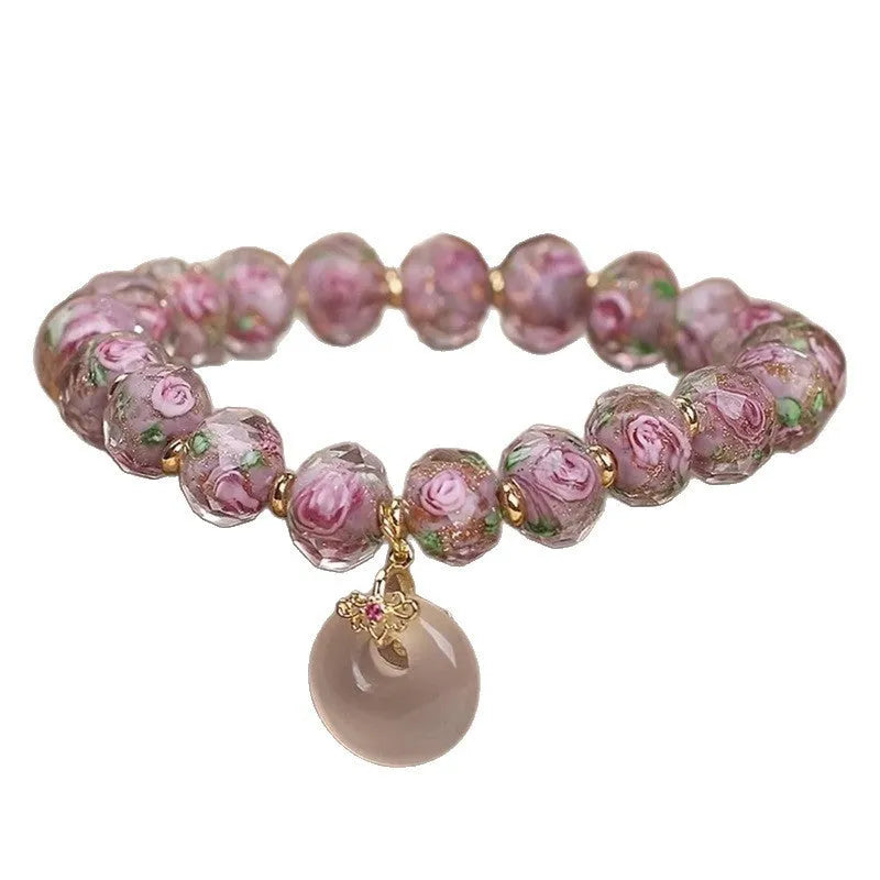 Purple glass flower amethyst bracelet with peace buckle on white background