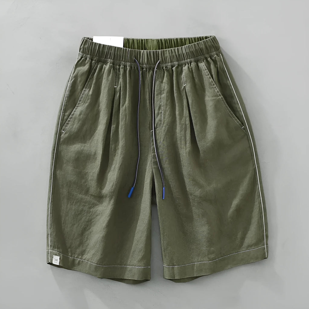 Men's loose fit linen shorts in green on a hanger, showing straight leg and drawstring waist.