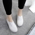 Low-top casual canvas shoes on a flat heel, shown in various colours including black, white, grey, and pink.