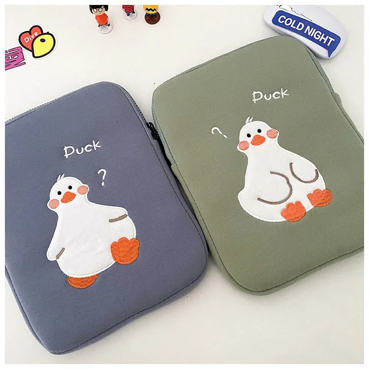 Blue cotton tablet case with embroidered cartoon duck design and a silver zipper.