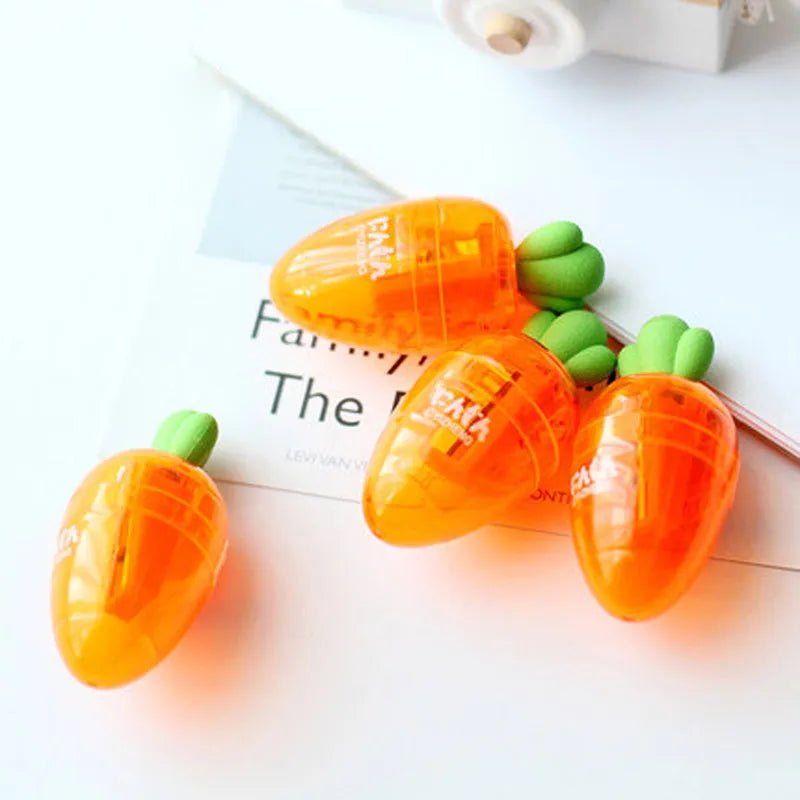 Orange carrot-shaped plastic pencil sharpener on a white background.