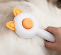 Self-cleaning cat grooming brush with stainless steel bristles in greenish white and orange white colour options