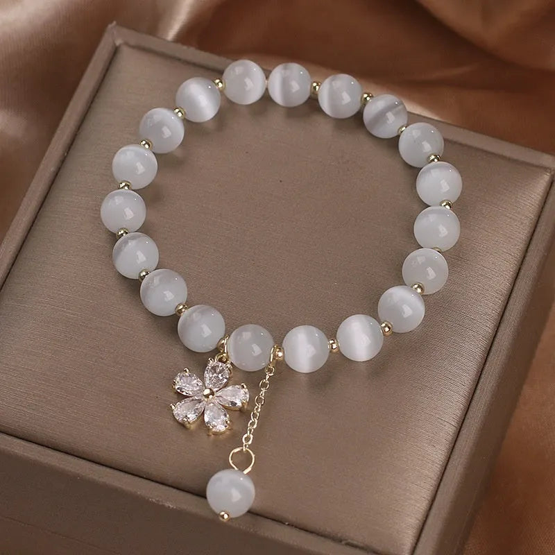 Women's white Cat's Eye crystal bracelet with flower tassel pendant and safety buckle closure