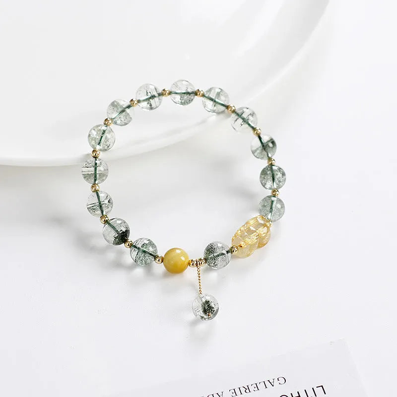 Green phantom quartz bracelet with geometric charm and gold rutilated quartz stones