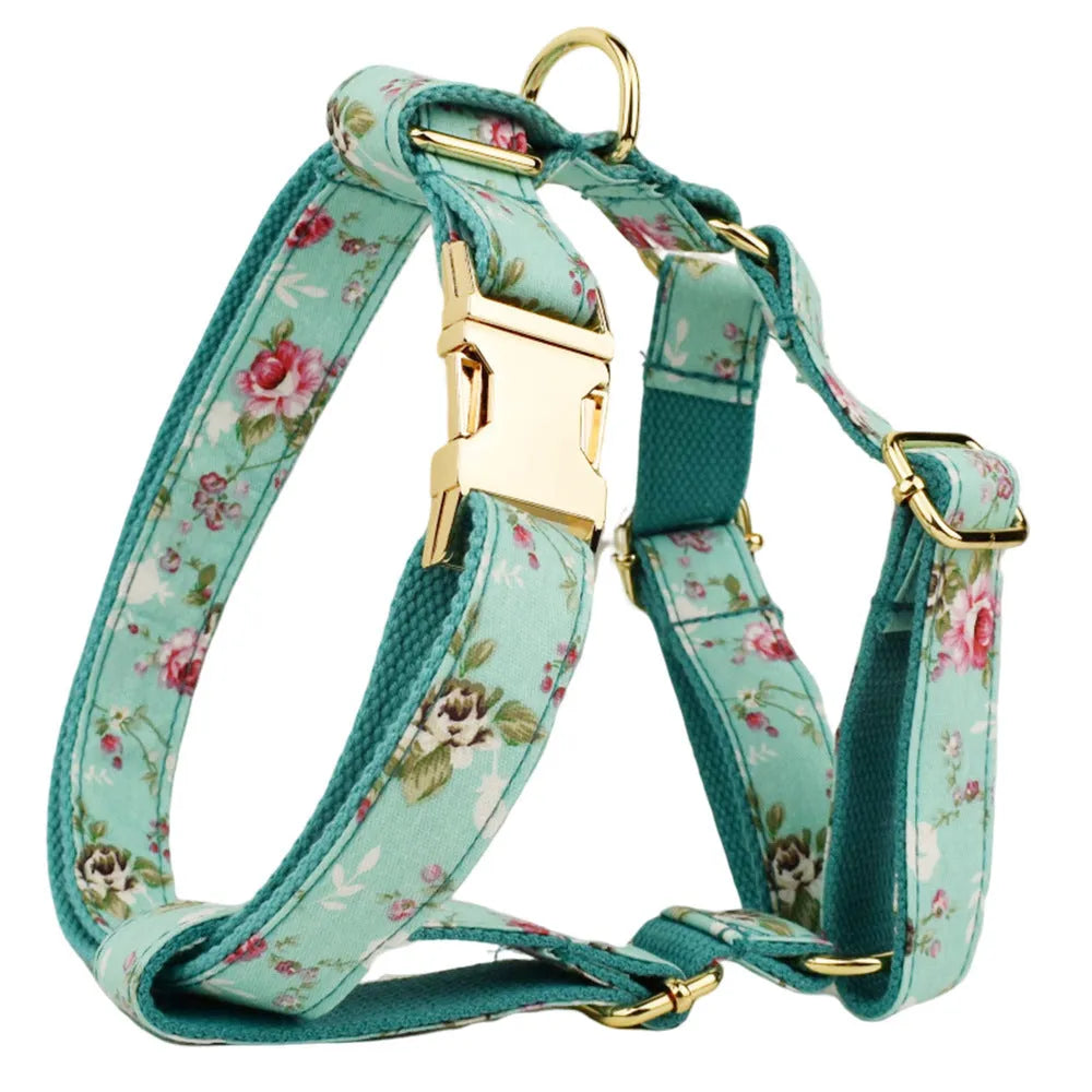 Four-piece dog accessory set with rose print bow, green fabric collar, leash and vest