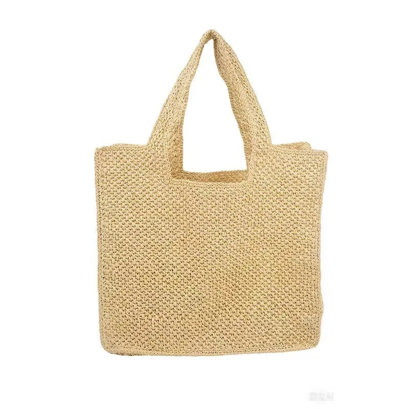 Woven straw tote bag with double shoulder straps in a horizontal square shape, shown in a neutral colour.