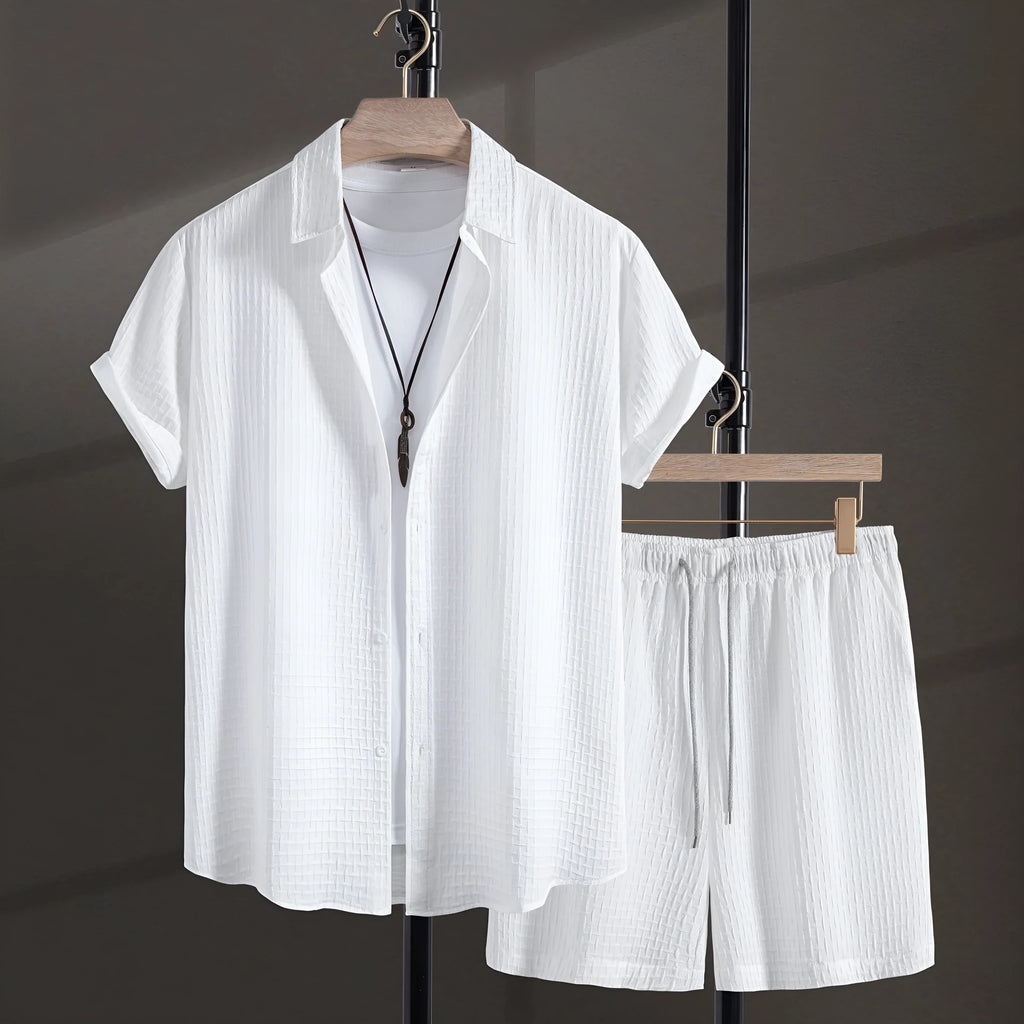 Men's white cotton blend beach suit with short sleeve shirt and loose-fitting shorts on a hanger.
