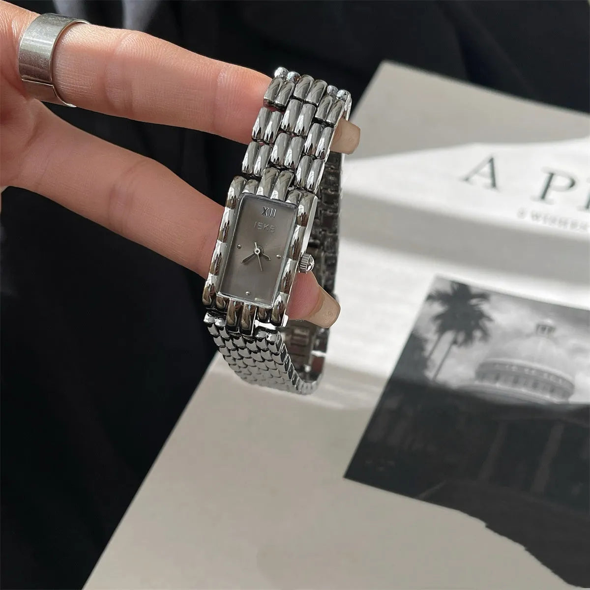Women's silver and gold mid-ancient bracelet watch with 15mm dial and butterfly clasp.