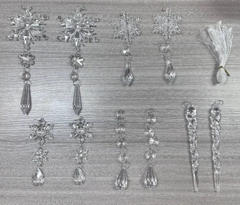 Ten clear acrylic icicle-shaped Christmas ornaments with white ribbons for hanging.
