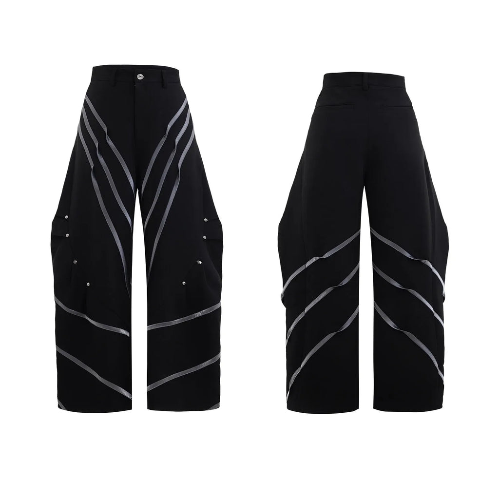 Men's black polyester trousers with metal rivet stripe and front pleats on a white background.