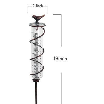 Cast iron hummingbird-shaped rain gauge with glass measurement tube showing 0-800ml capacity scale