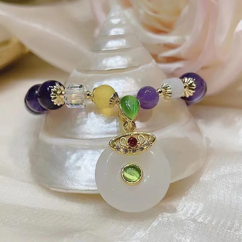 Purple amethyst crystal bracelet with ethnic money bag pendant and peace buckle closure